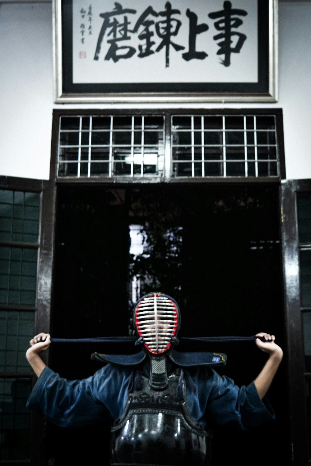a person with a mask on holding a large object