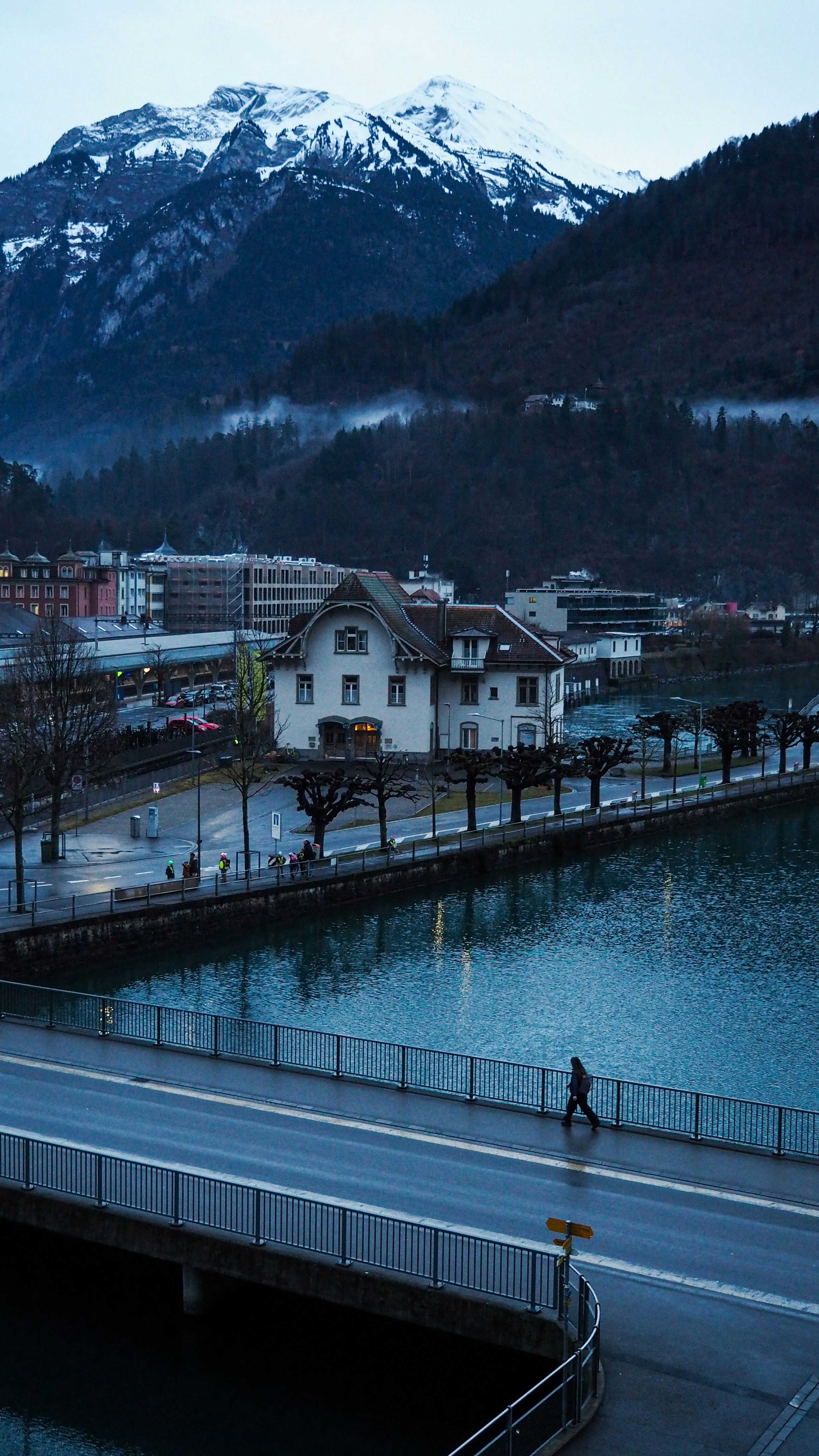 a person riding a bike on a road near a body of water