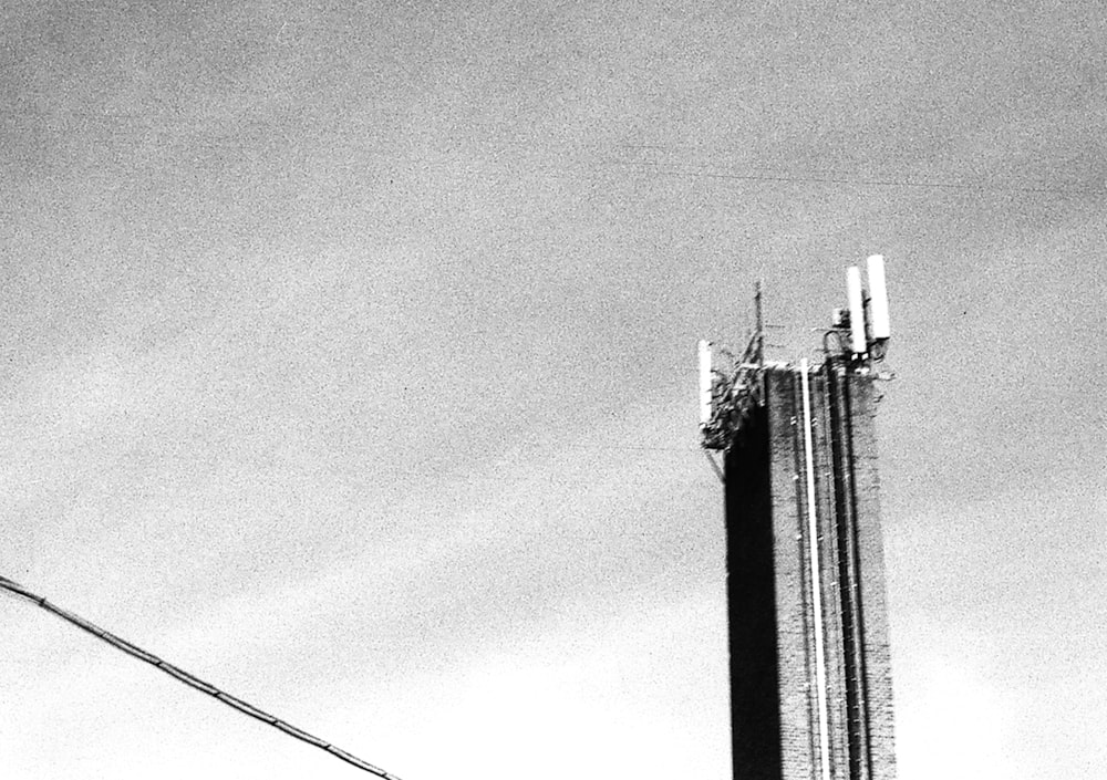 a black and white photo of a cell phone tower