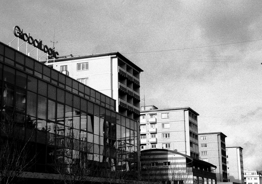 a black and white photo of a building with a sky background