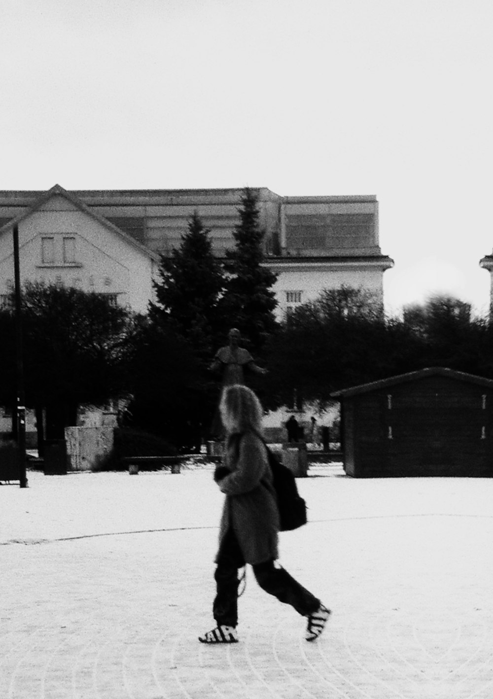 a black and white photo of a person on a snowboard