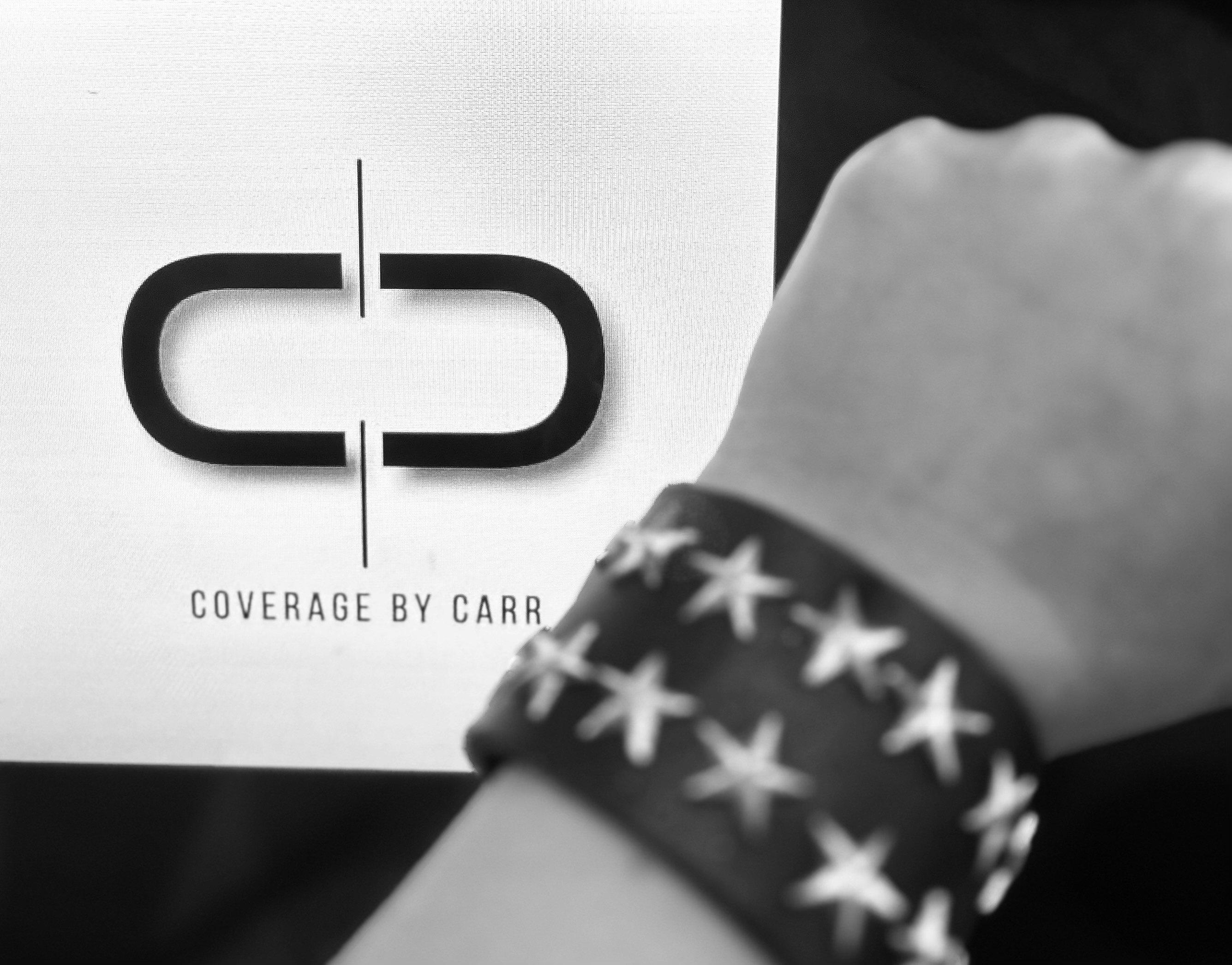 a person wearing a bracelet with stars on it