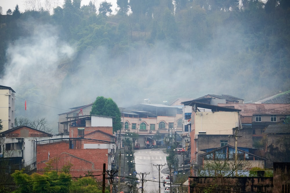 smoke billows from the top of a hill above a city