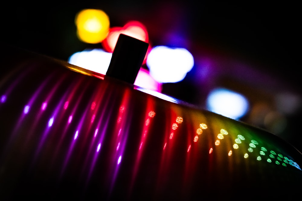 a close up of a colorful object in the dark
