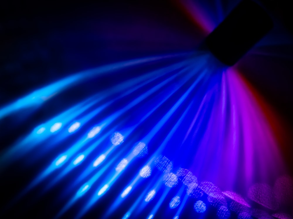 a close up of a colorful light in the dark