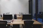 a room with two desks and two monitors