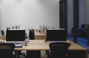 a room with two desks and two monitors