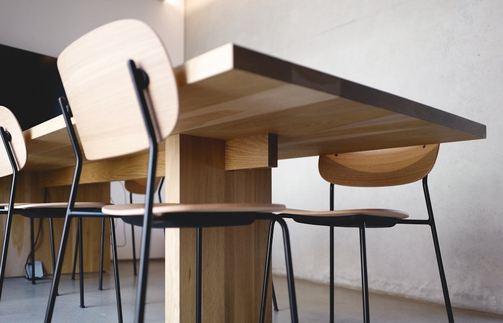 a group of chairs sitting under a wooden table