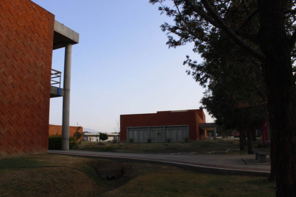 a red brick building sitting next to a tree