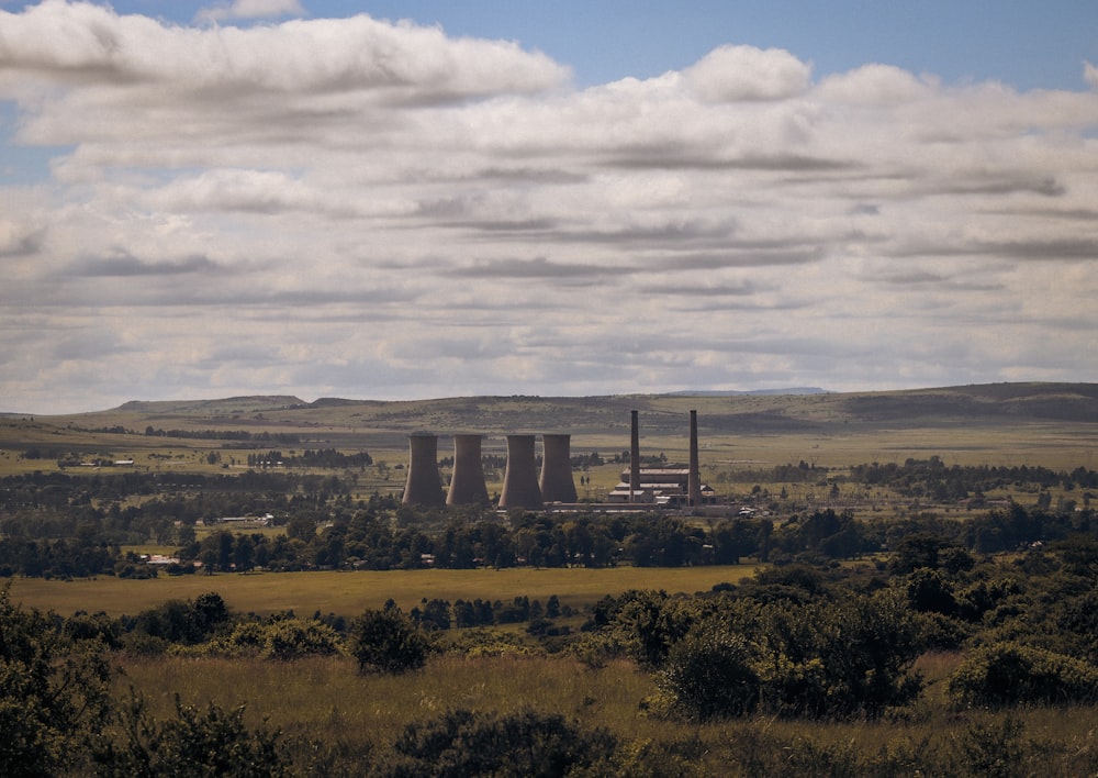 a view of a factory in the middle of a field