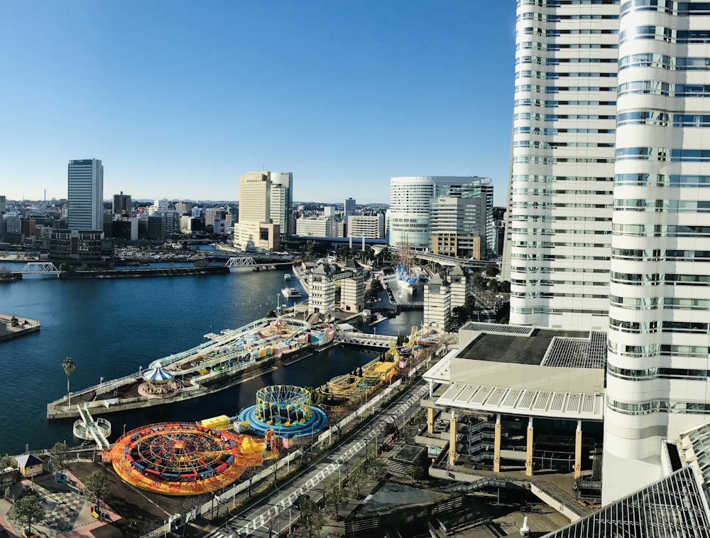 an aerial view of a city with a carnival in the foreground