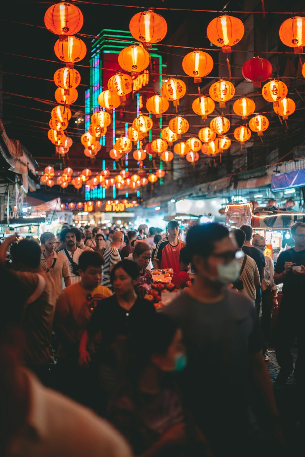 a large group of people standing around a market