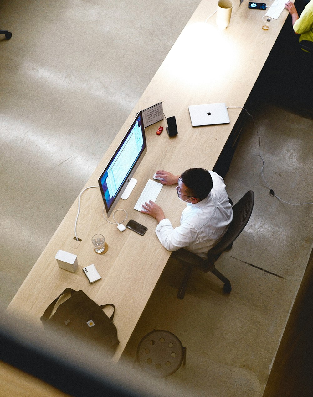 a man sitting at a desk working on a computer