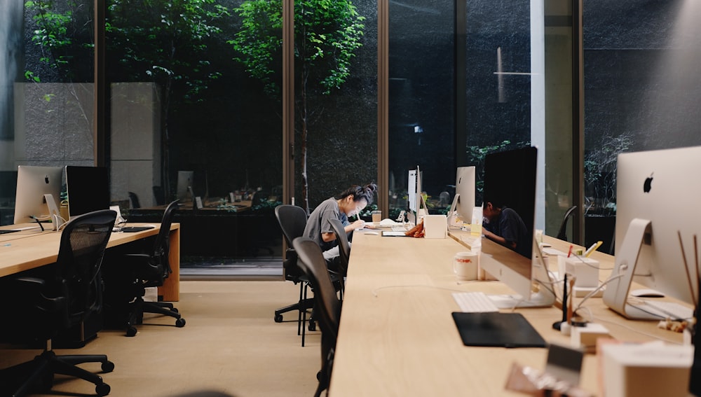 a man sitting at a desk working on a computer