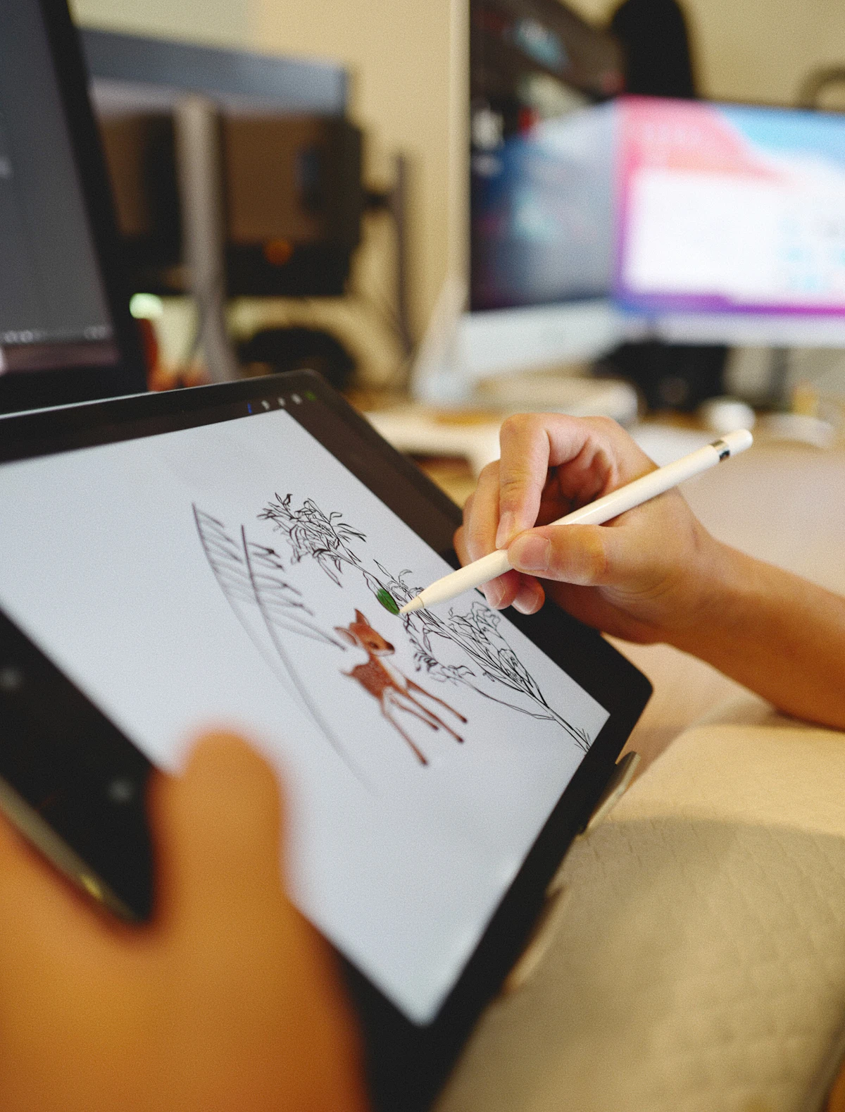 A person drawing on an iPad with an Apple Pencil.