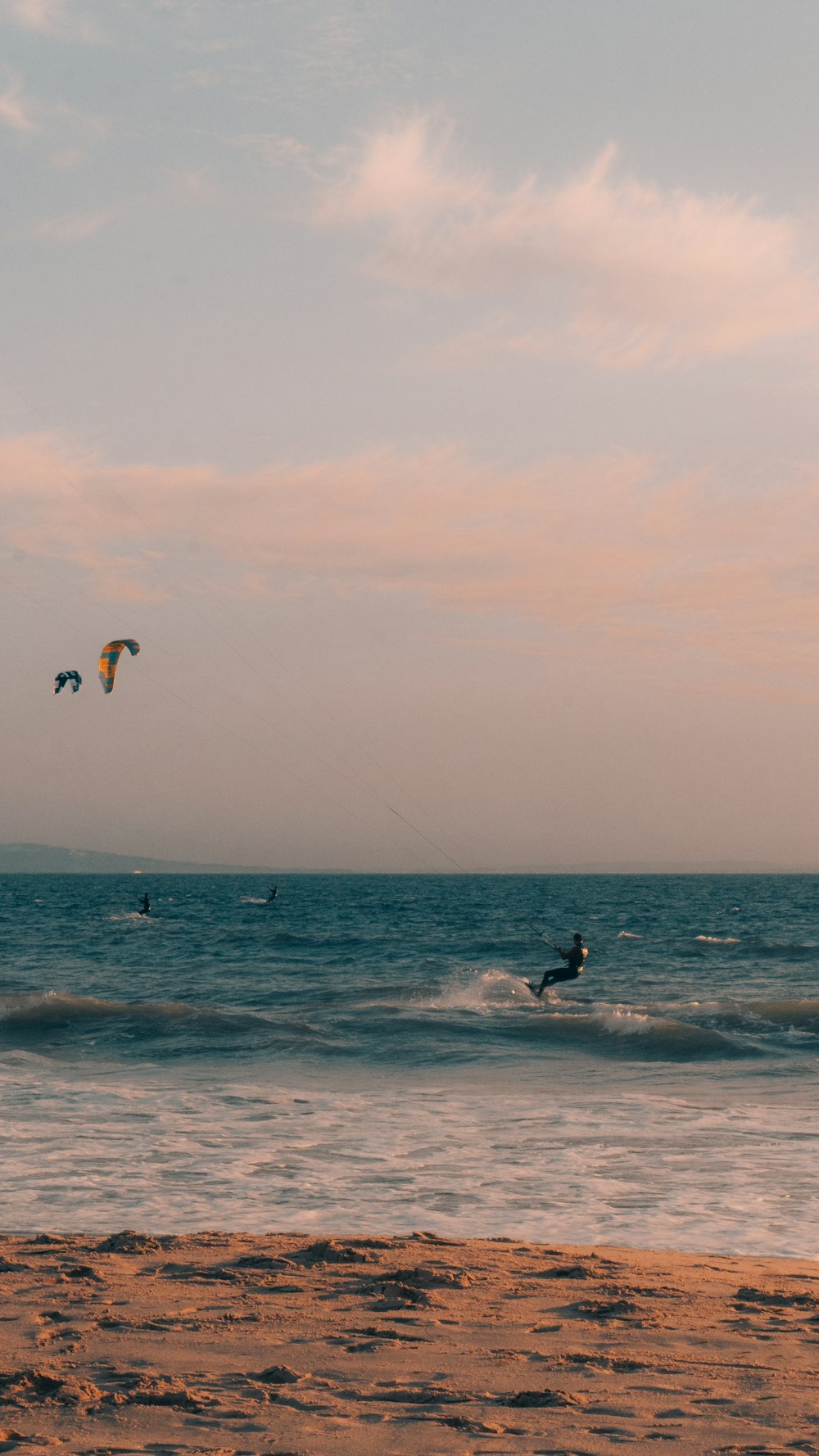 a person para sailing on the ocean at sunset