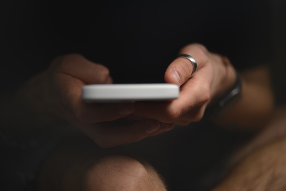 a close up of a person holding a cell phone