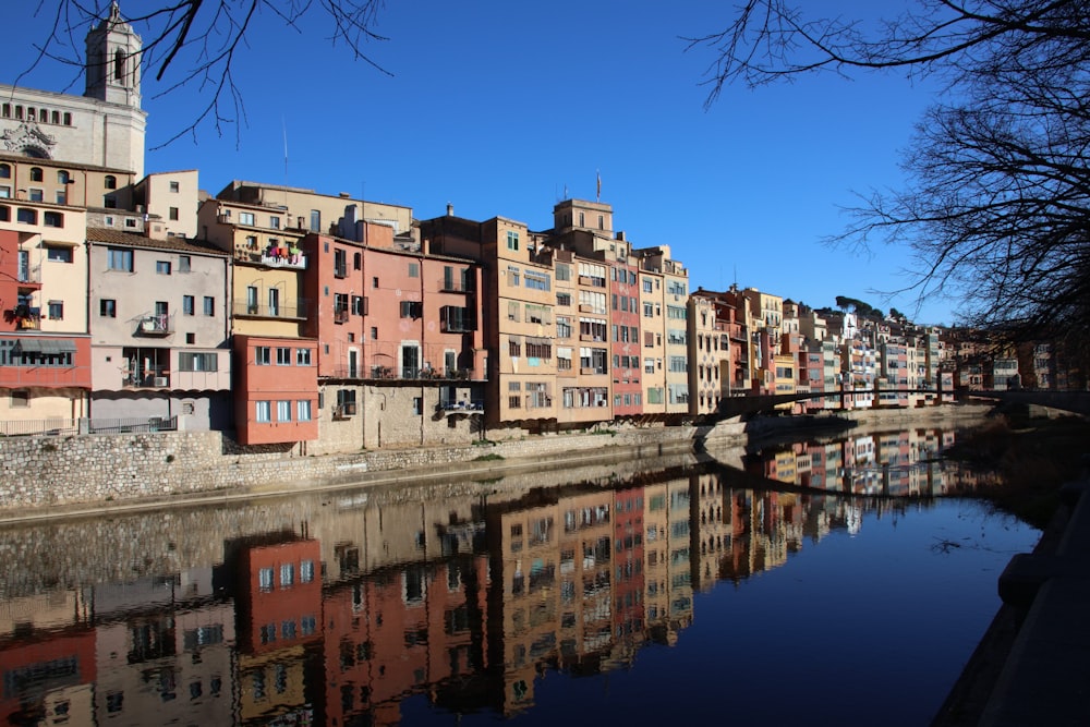 a river running through a city next to tall buildings