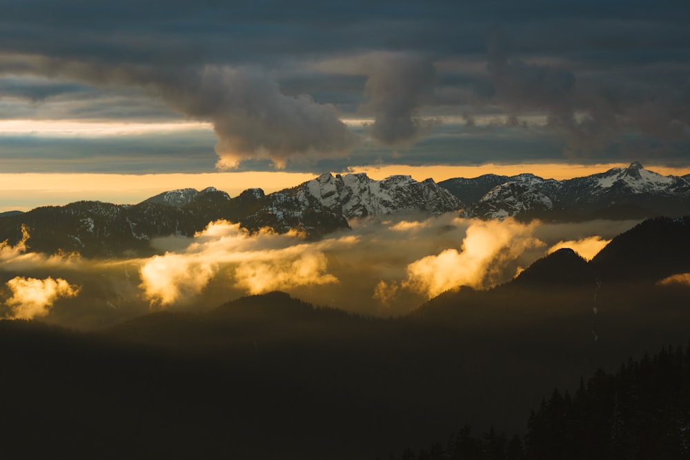 a view of a mountain range covered in clouds