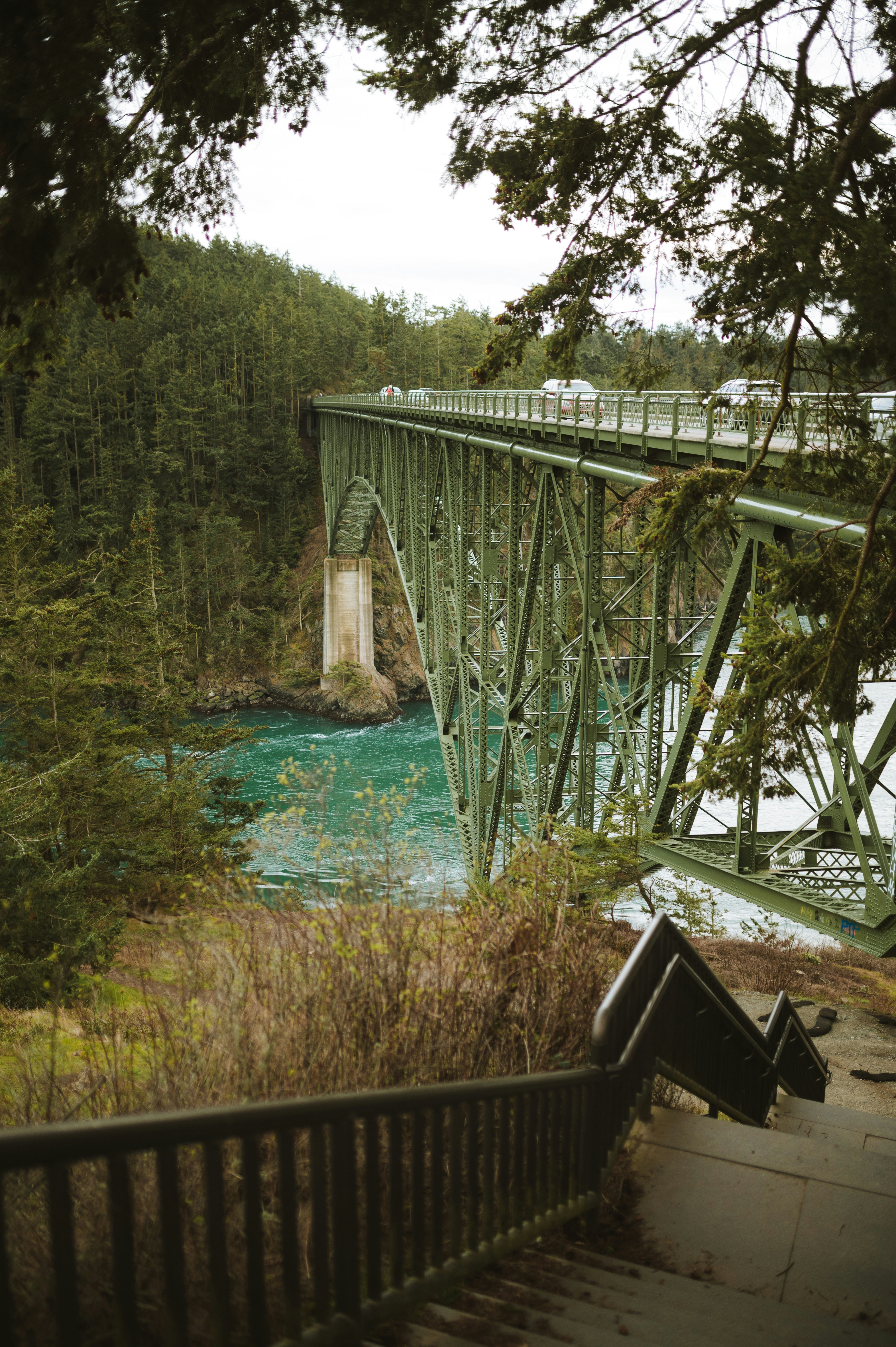 a bridge over a river with a train going over it