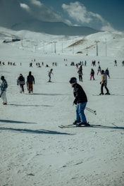 a group of people skiing down a snow covered slope