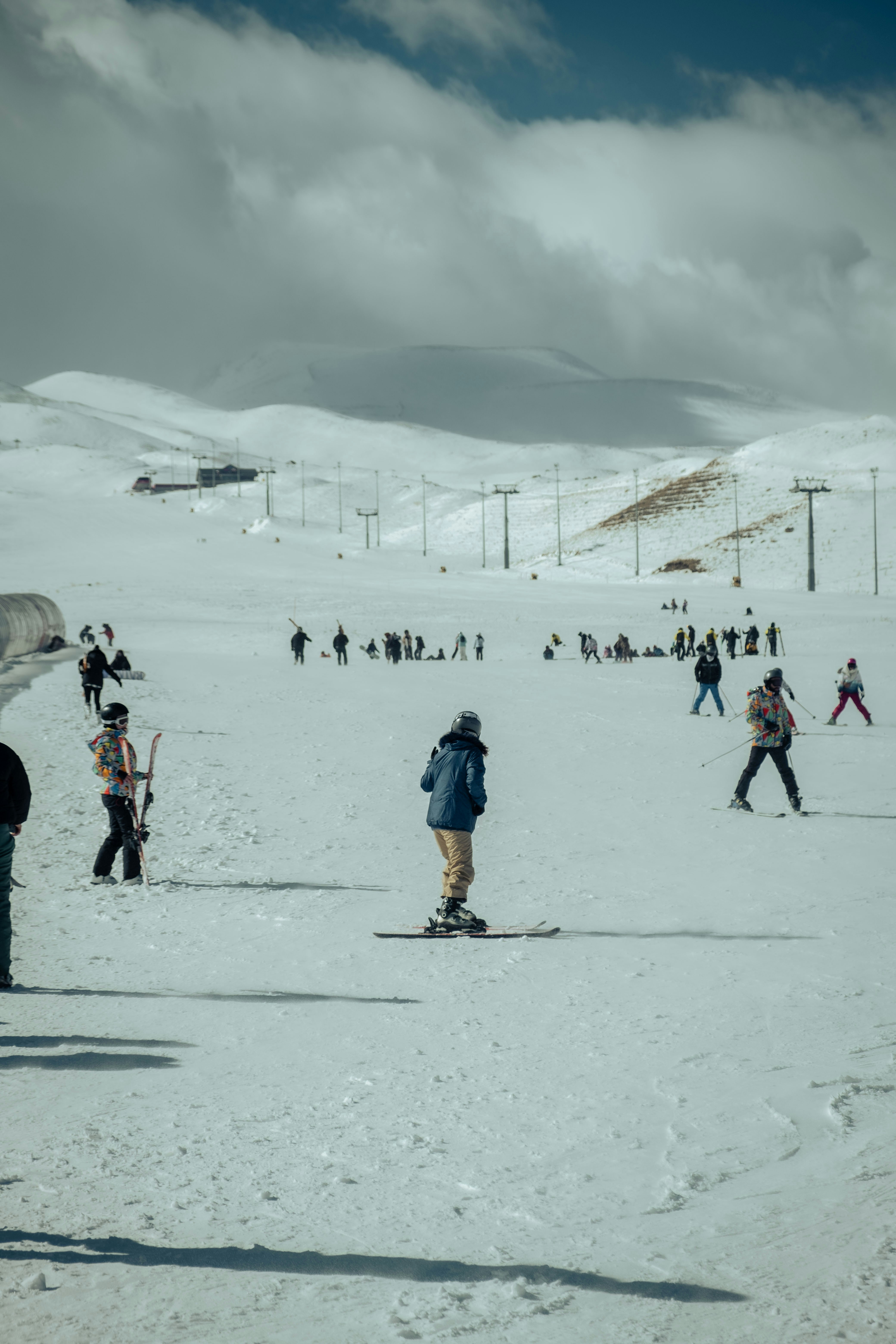 a group of people riding skis on top of a snow covered slope