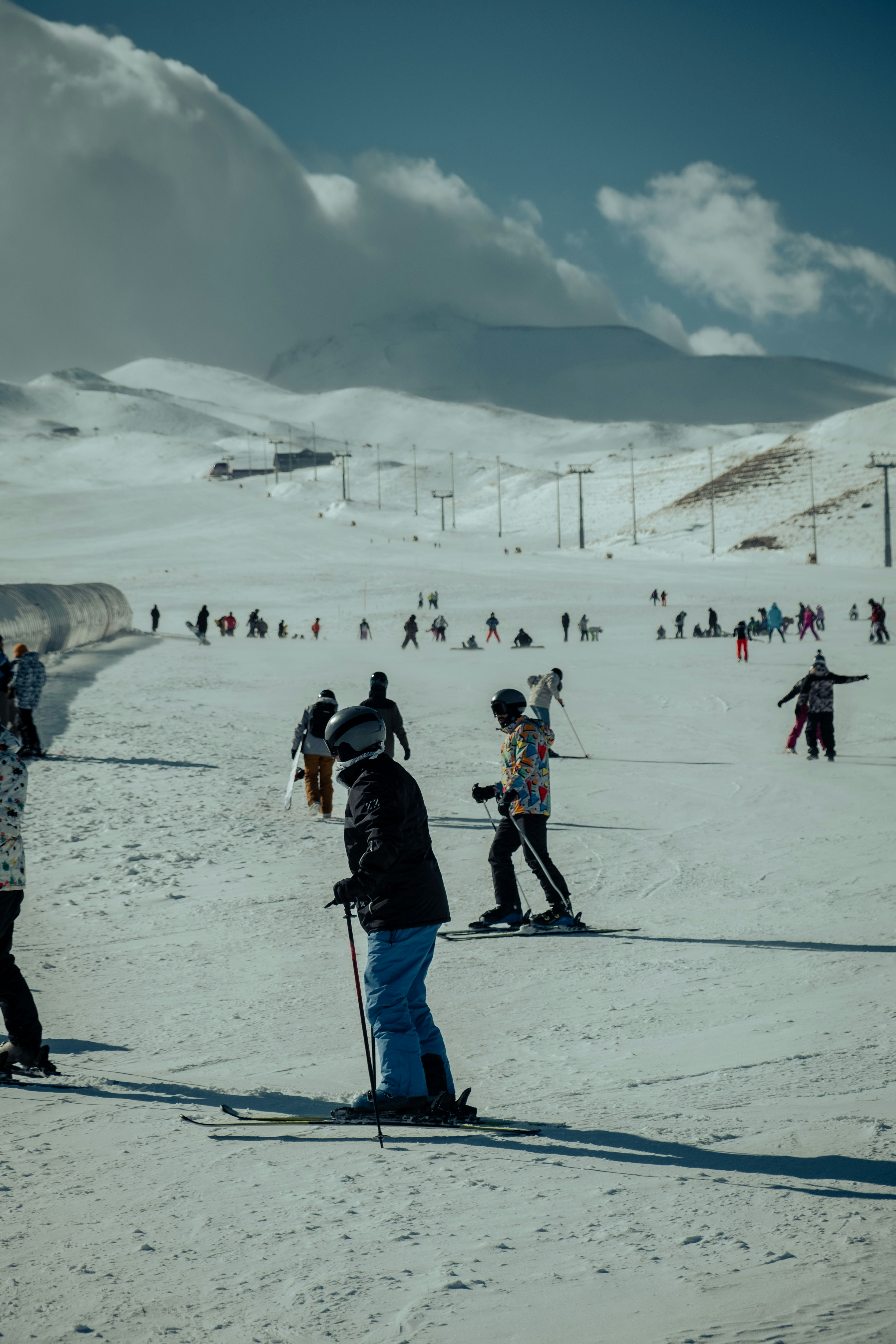 a group of people riding skis on top of a snow covered slope