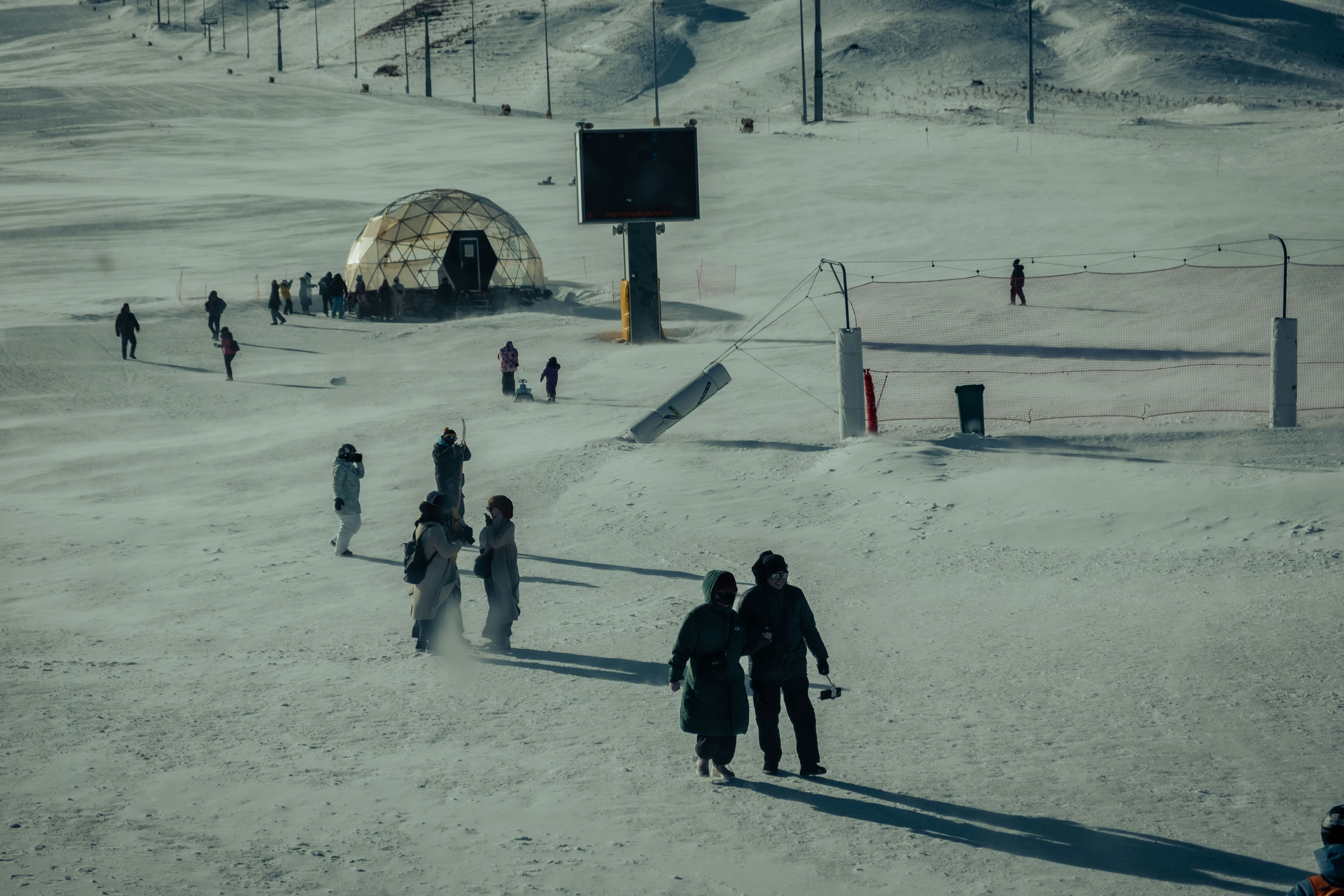 a group of people standing on top of a snow covered slope
