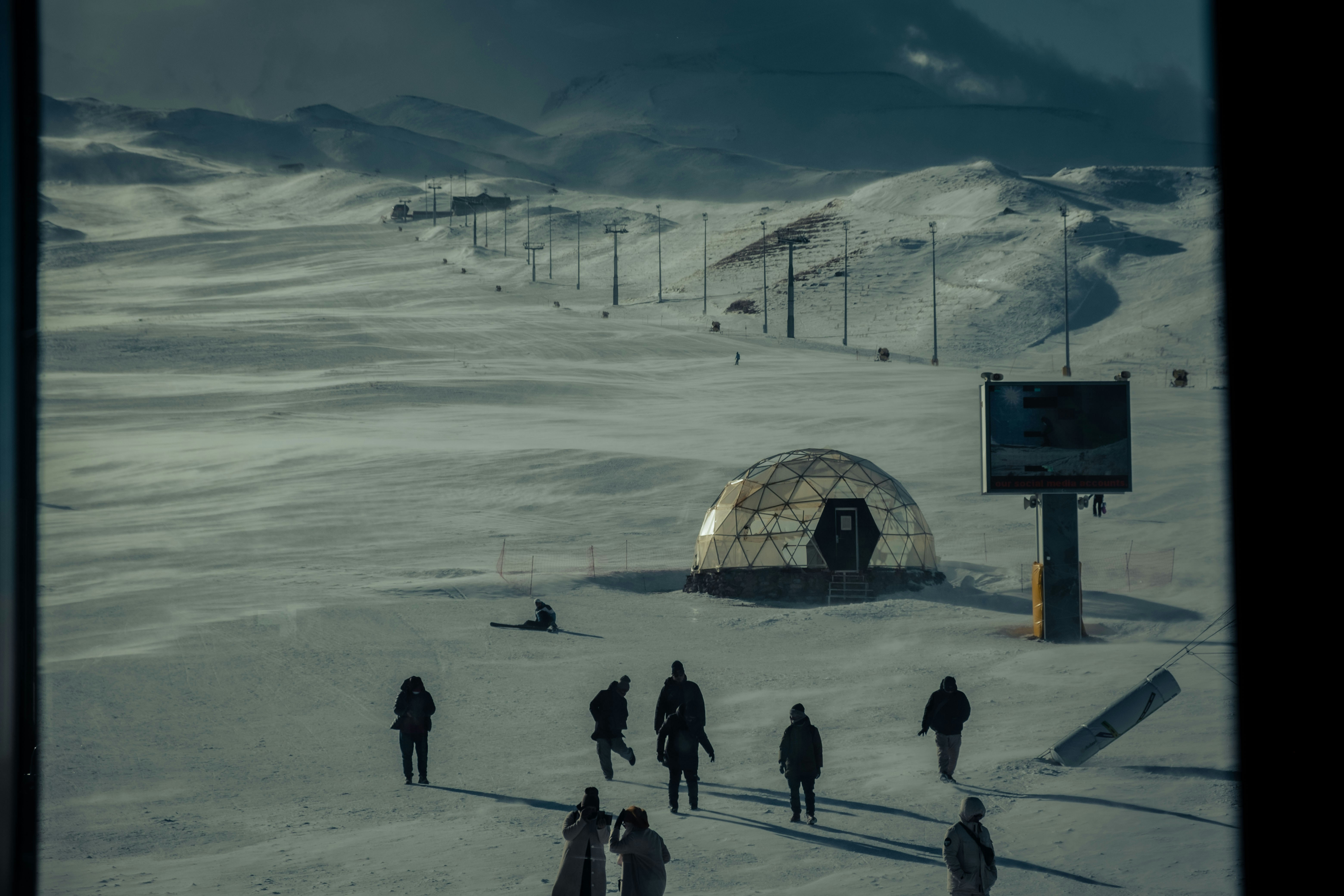 a group of people walking across a snow covered field