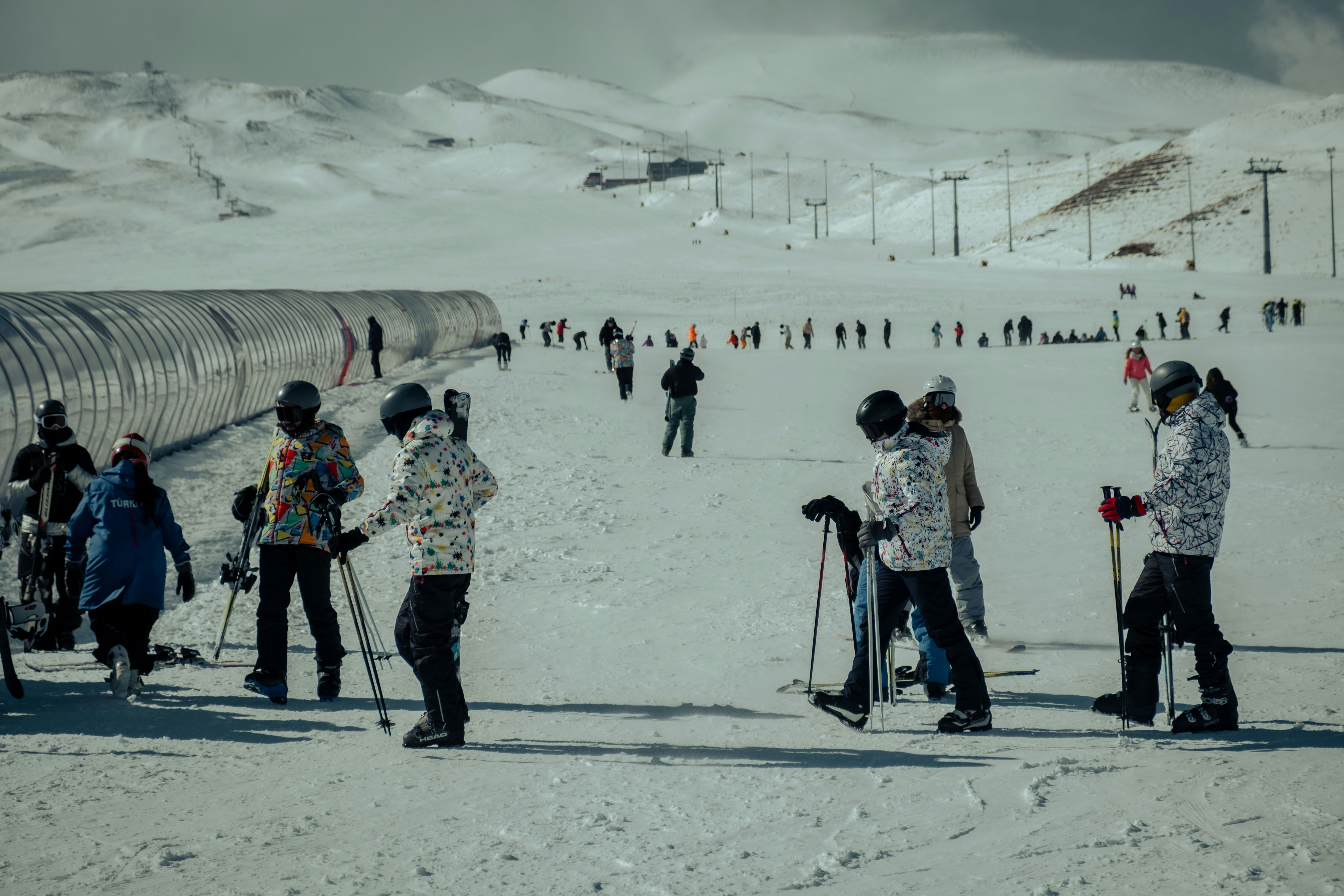 a group of people standing on top of a snow covered slope