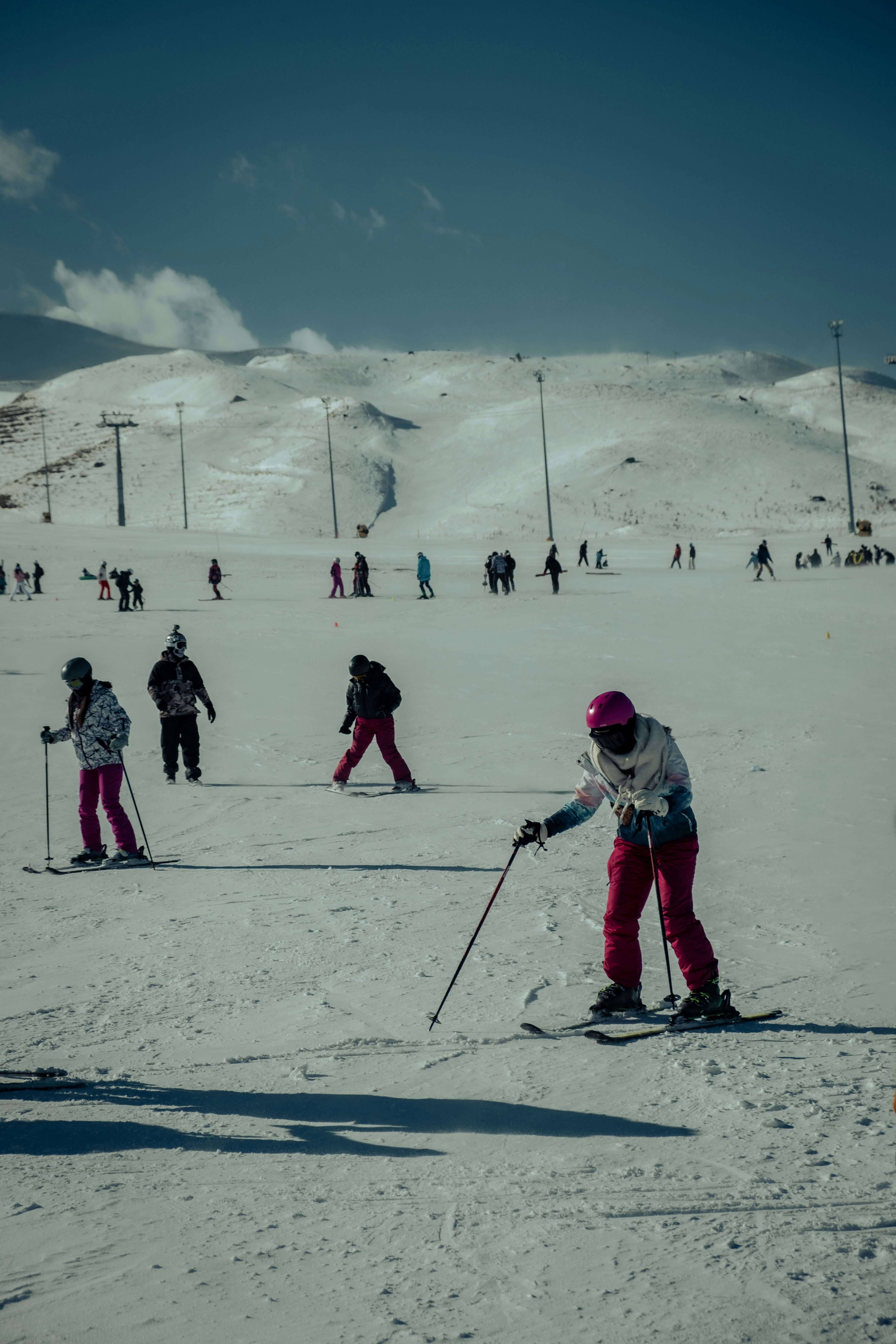 a group of people riding skis on top of a snow covered slope