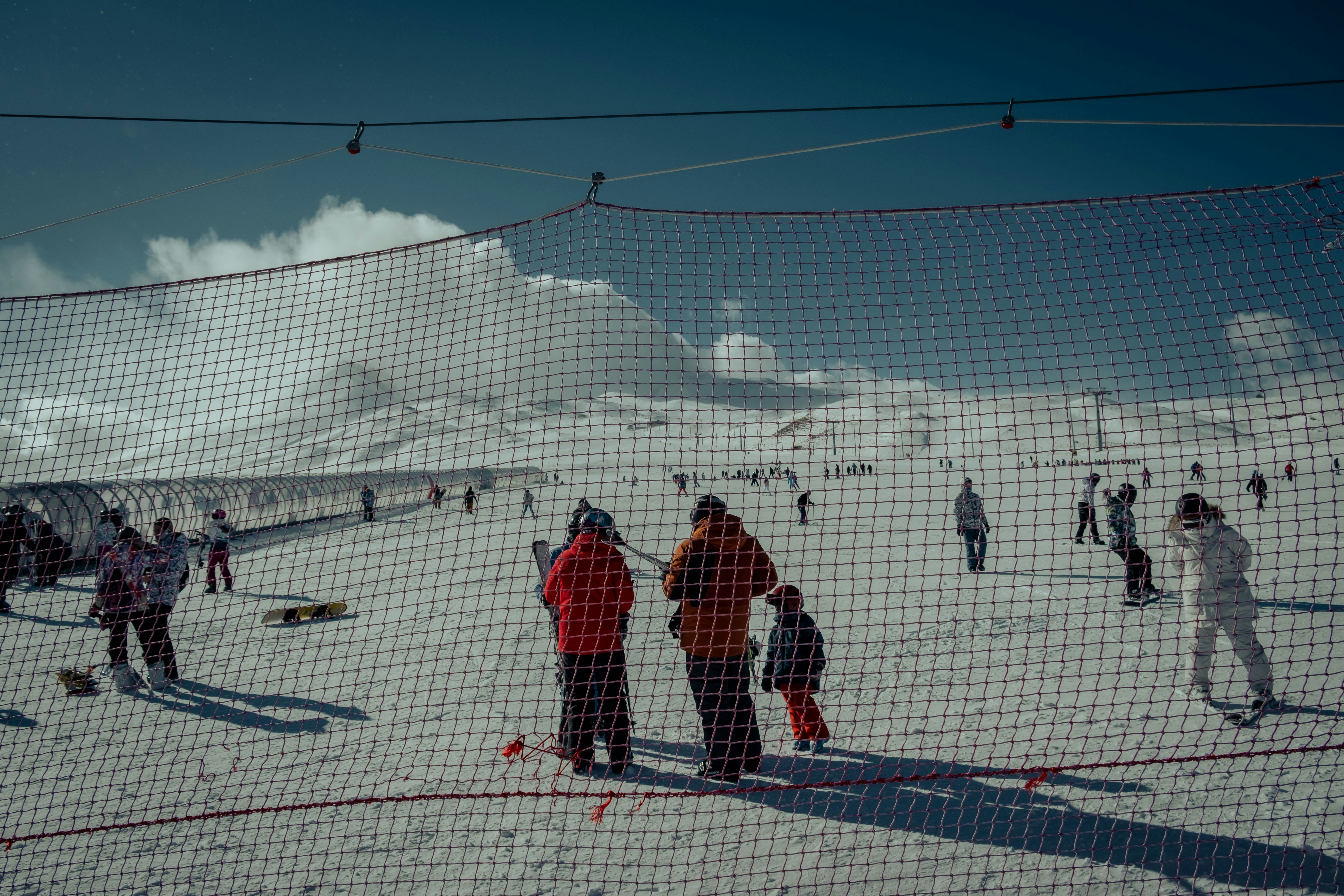 a group of people standing on top of a snow covered slope