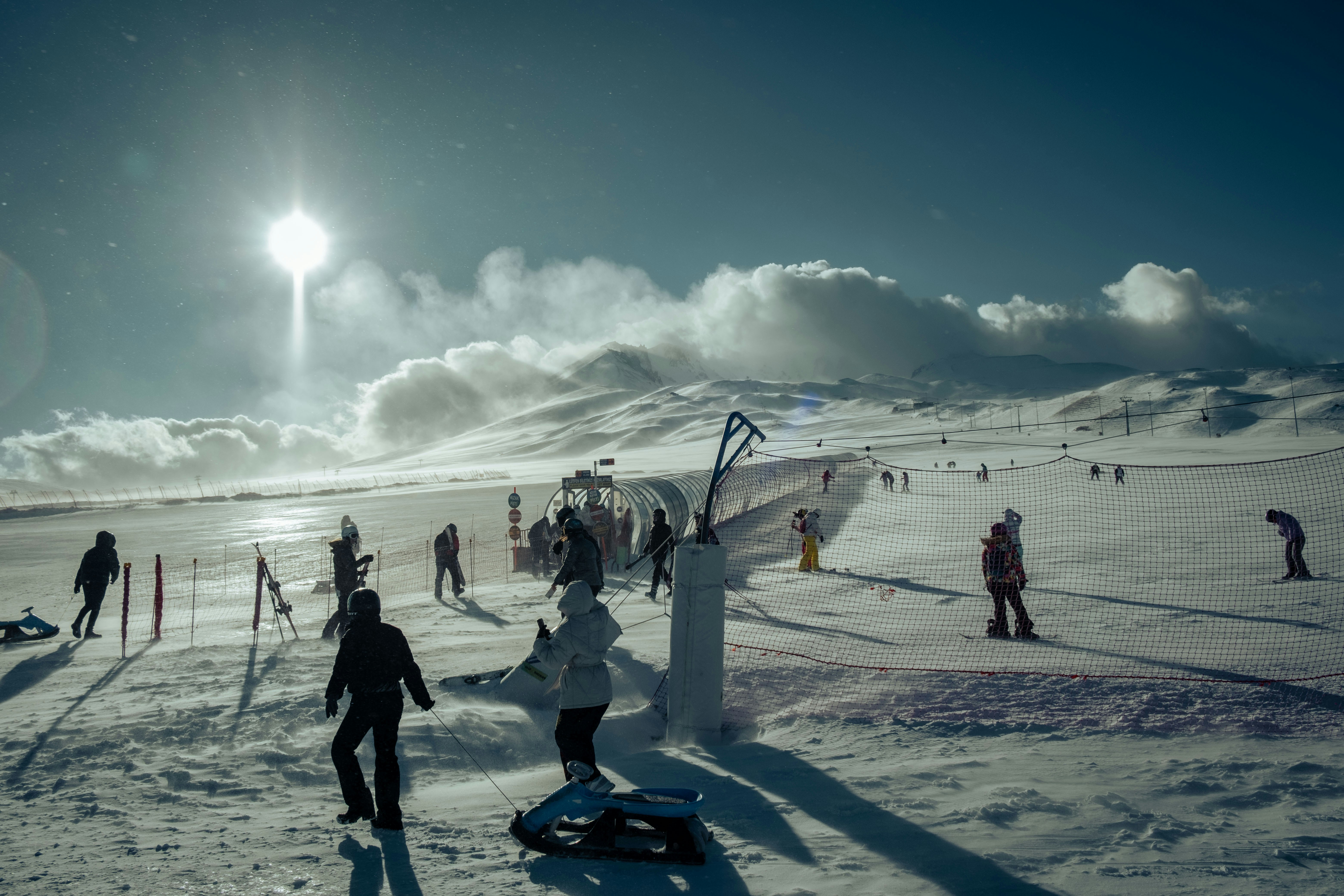 a group of people standing on top of a snow covered slope