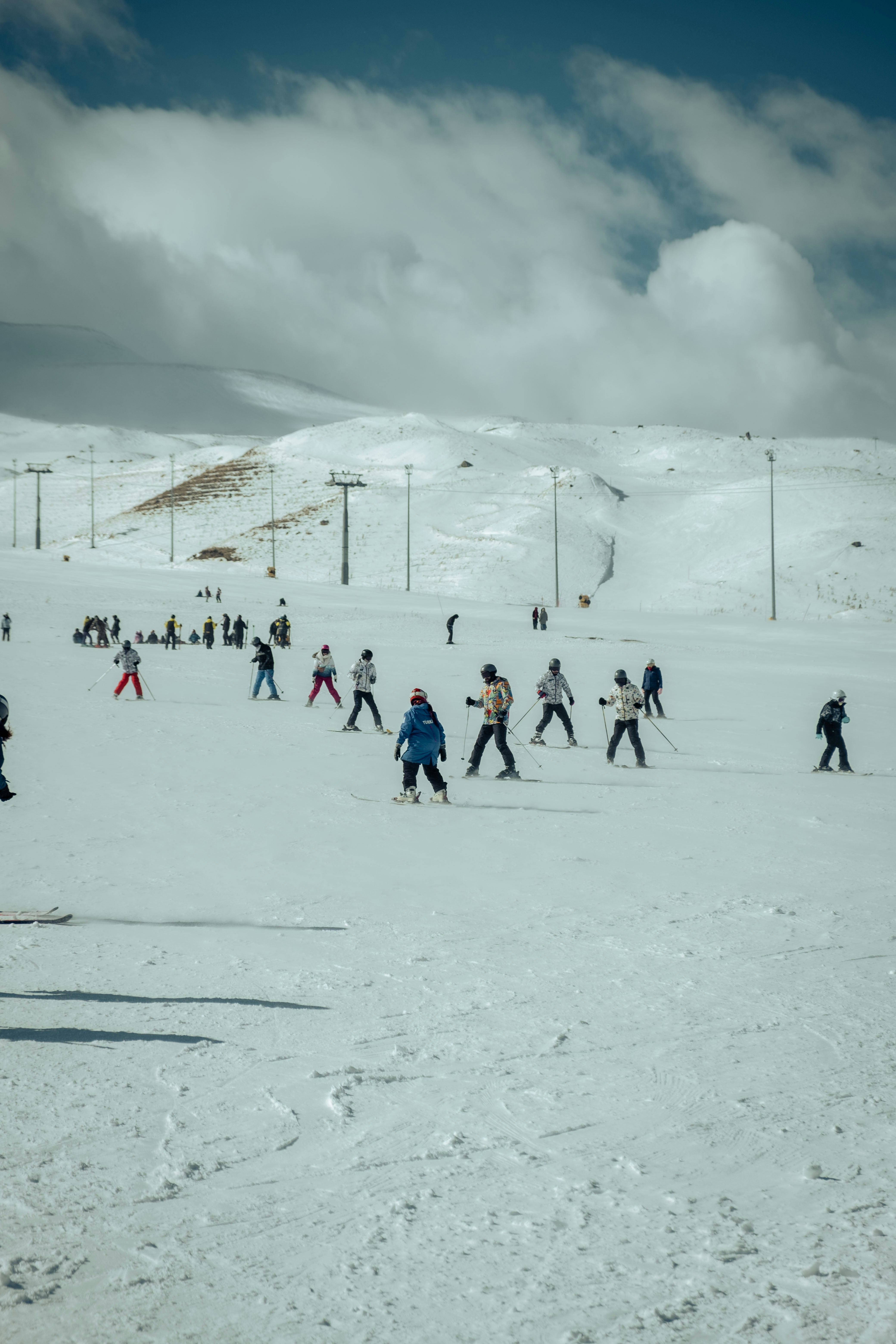 a group of people skiing down a snow covered slope