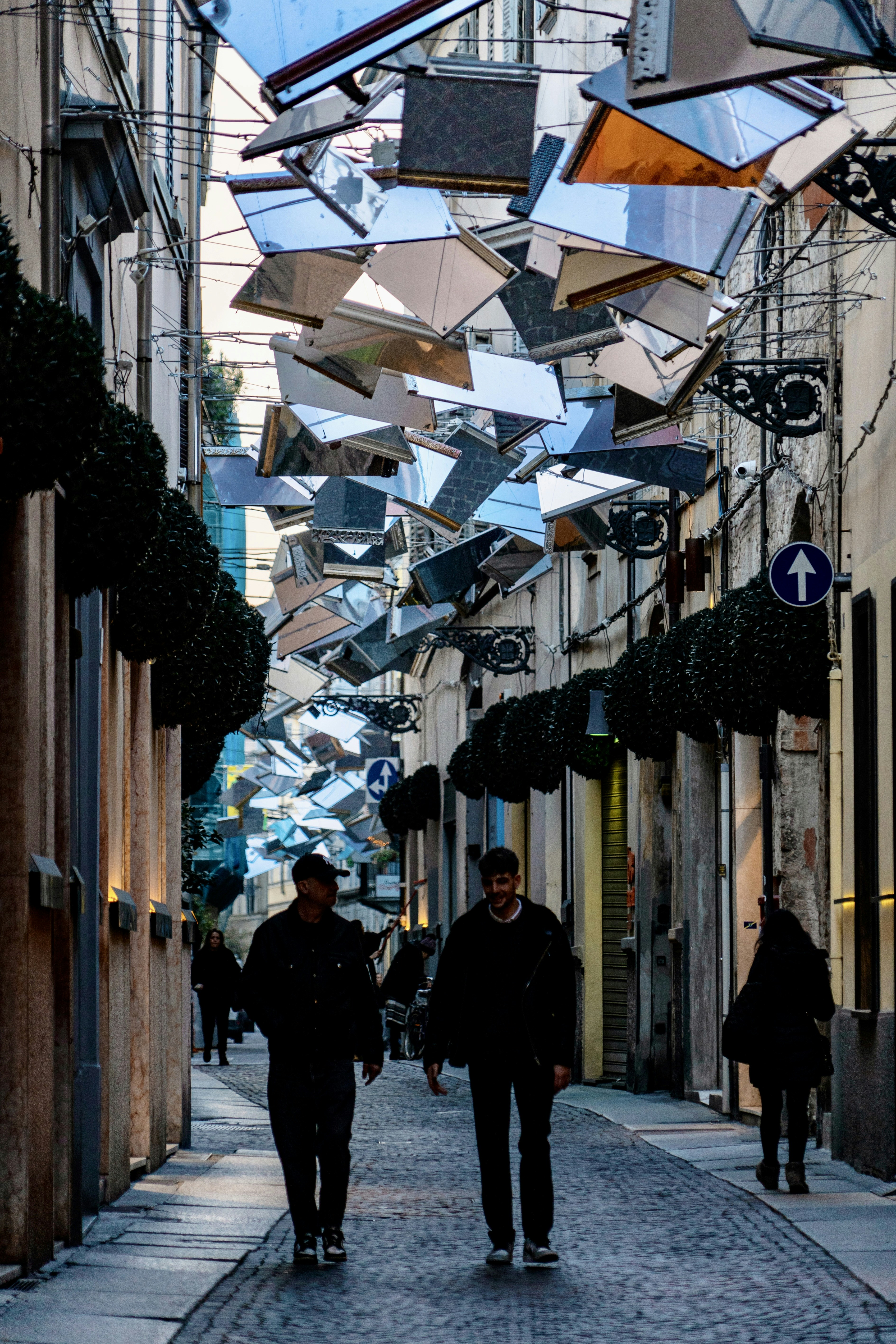 a couple of people walking down a street