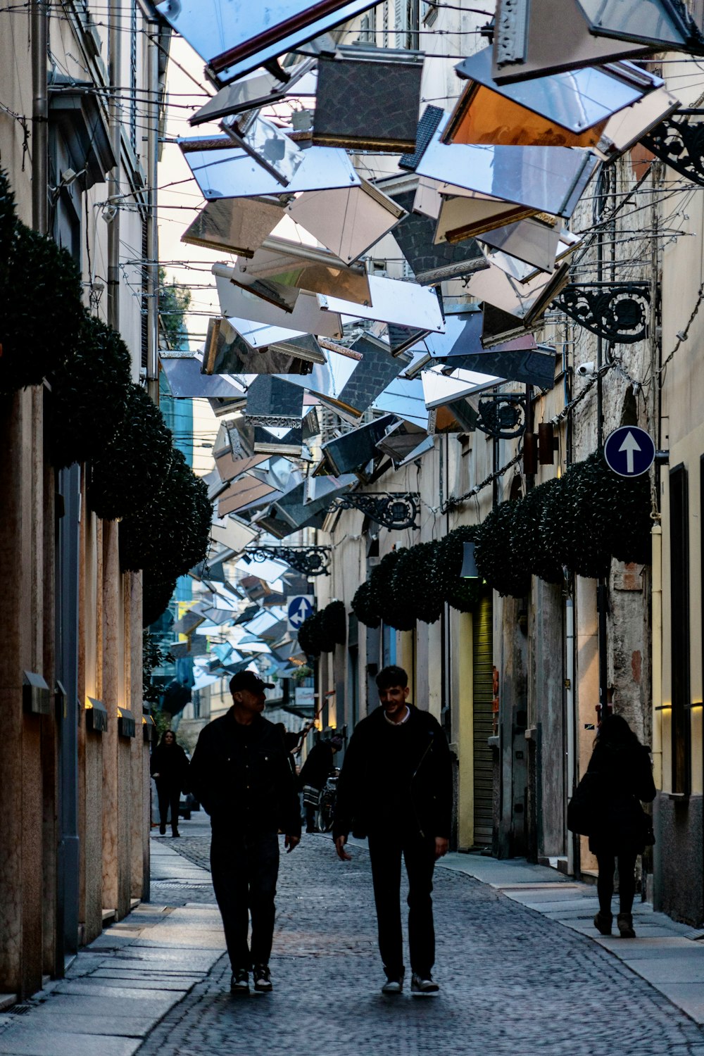 a couple of people walking down a street