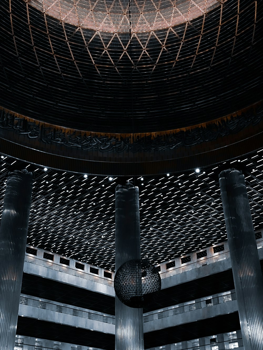 a large metal structure with a clock on top of it