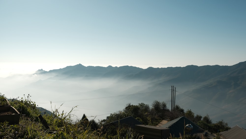 a view of a mountain range with a few houses in the foreground