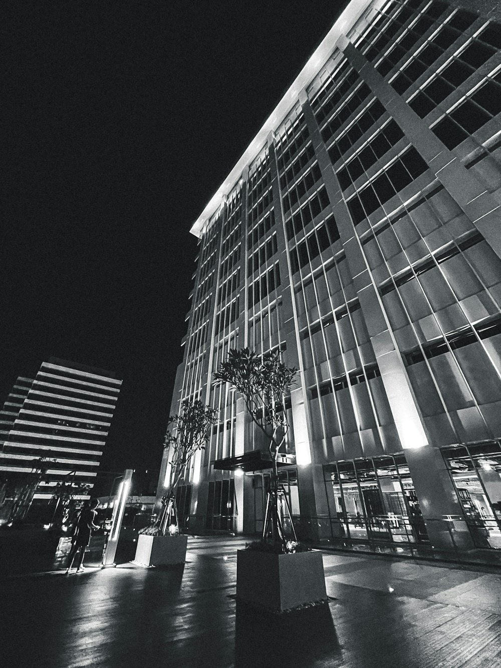 a black and white photo of a building at night