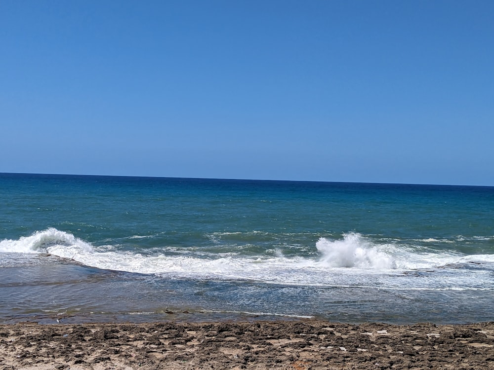 a man riding a surfboard on top of a wave in the ocean