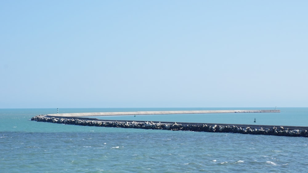 a large body of water sitting next to a pier