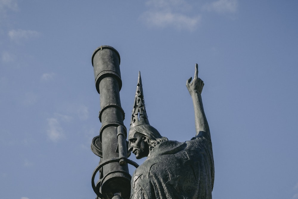 a statue of a woman holding a lamp post