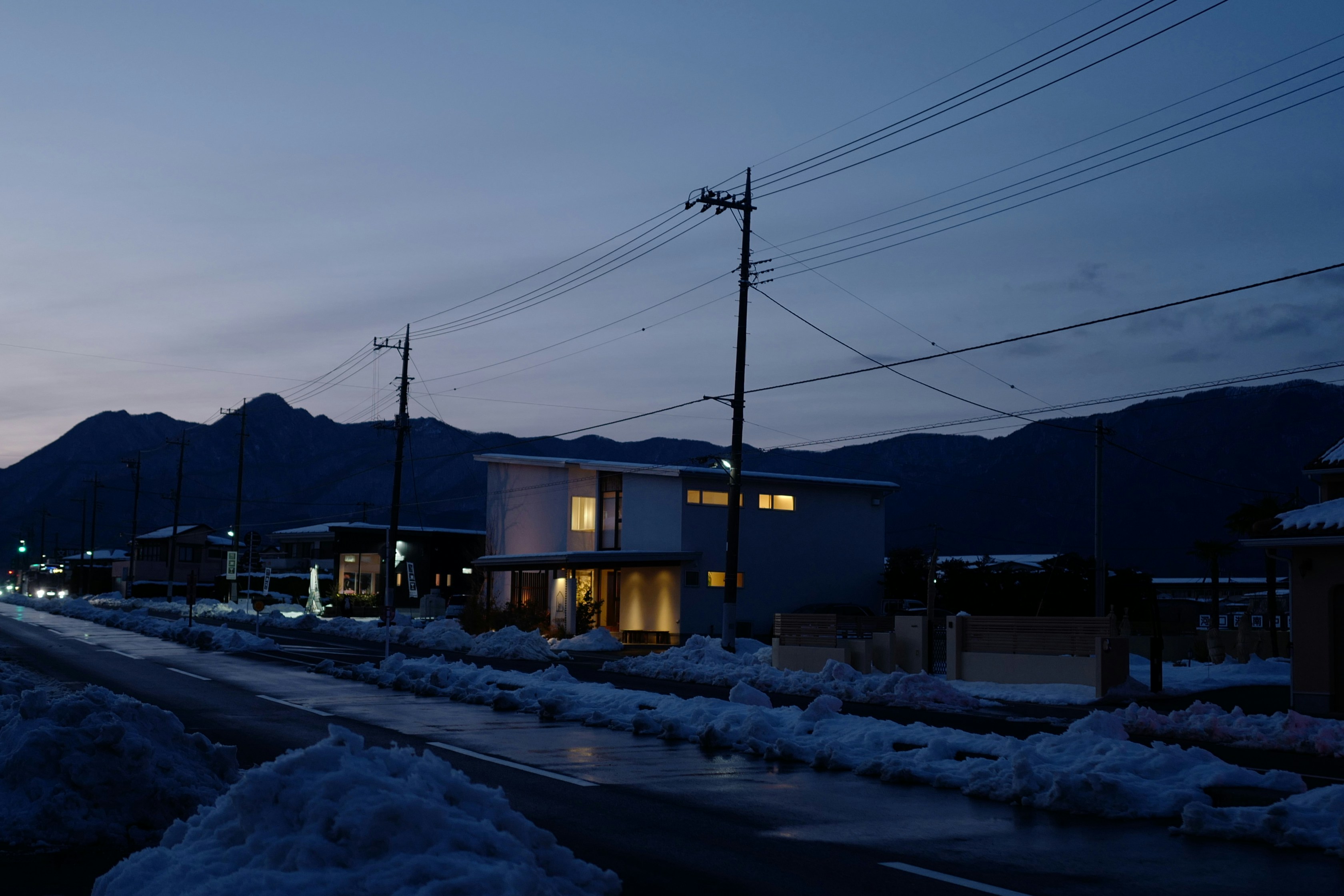 A street at night with snow on the ground photo – Free City Image on ...