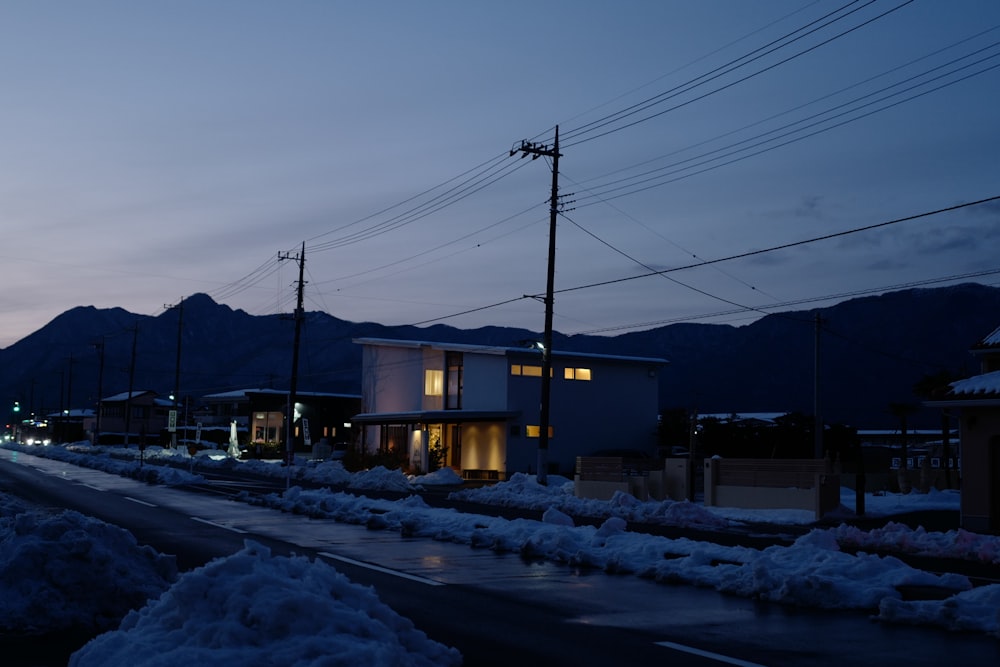 a street at night with snow on the ground