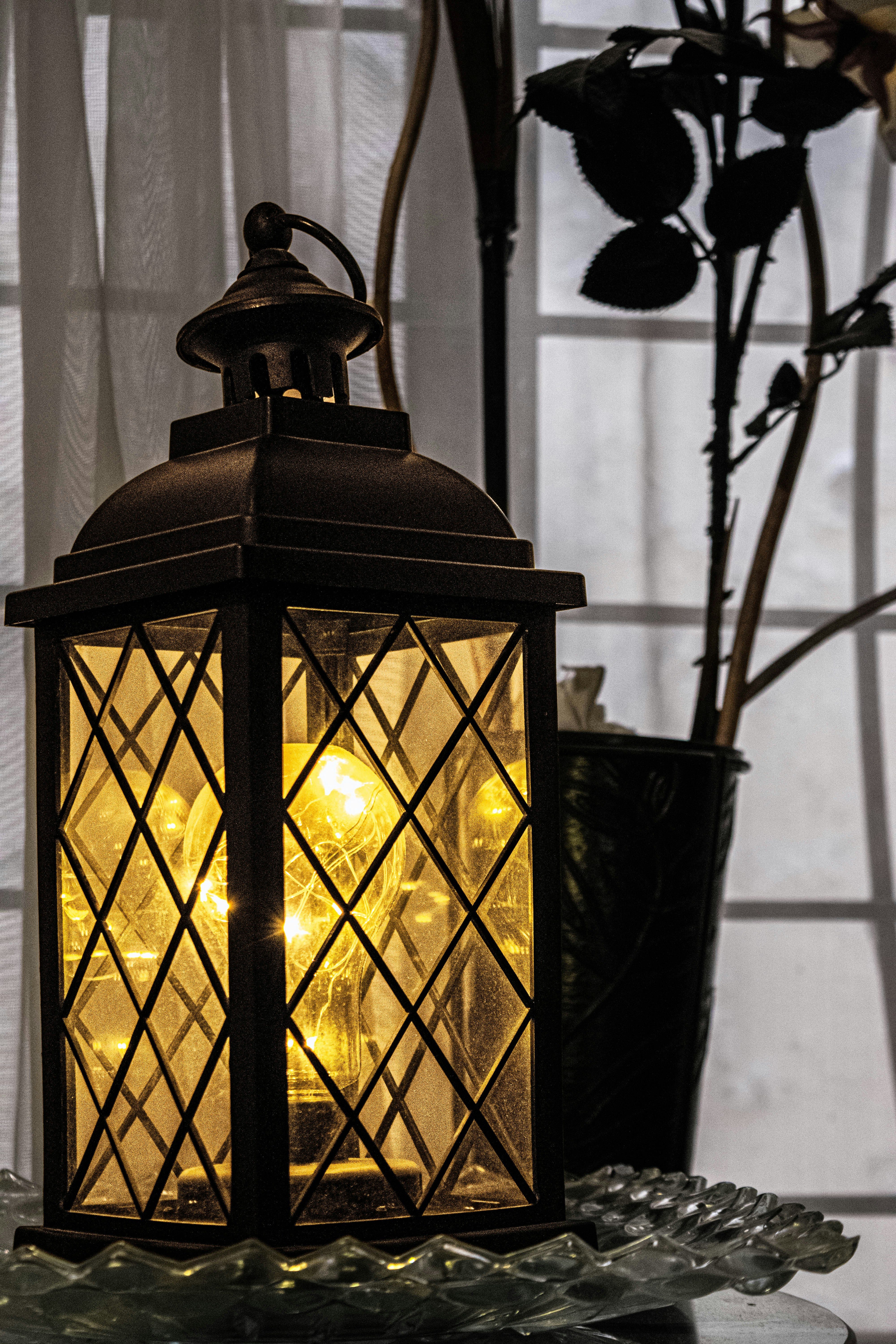 a lantern sitting on top of a glass table