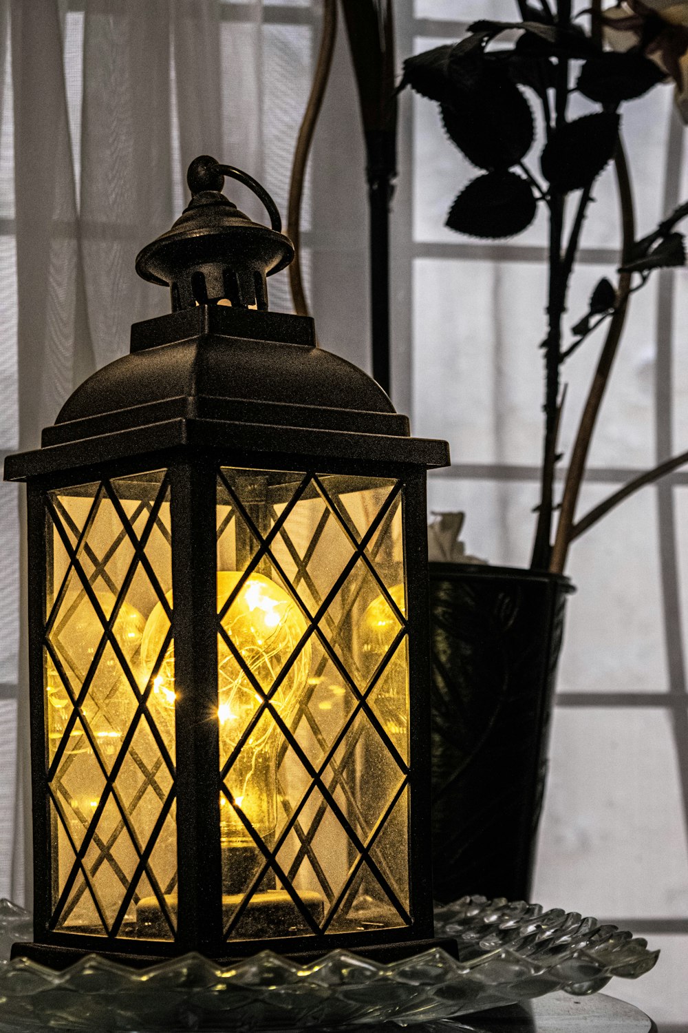 a lantern sitting on top of a glass table