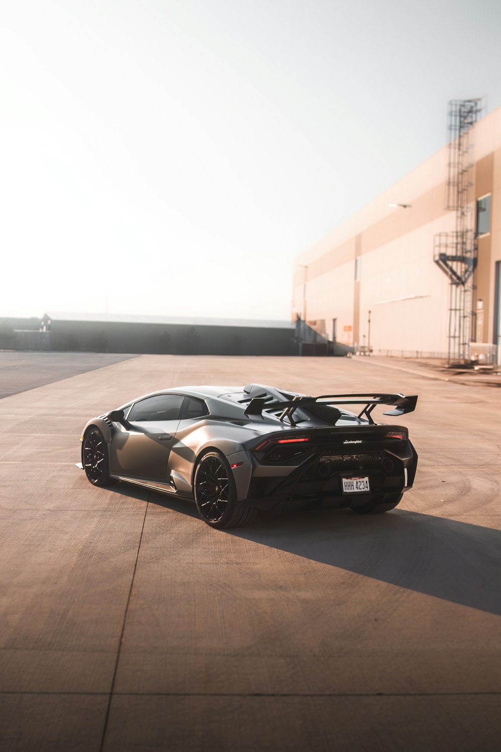 a black sports car parked in front of a building