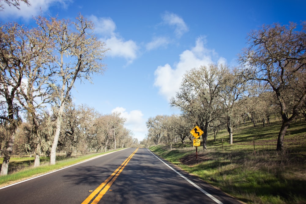 a road with a yellow sign on the side of it