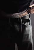 a man is wearing a belt and jeans