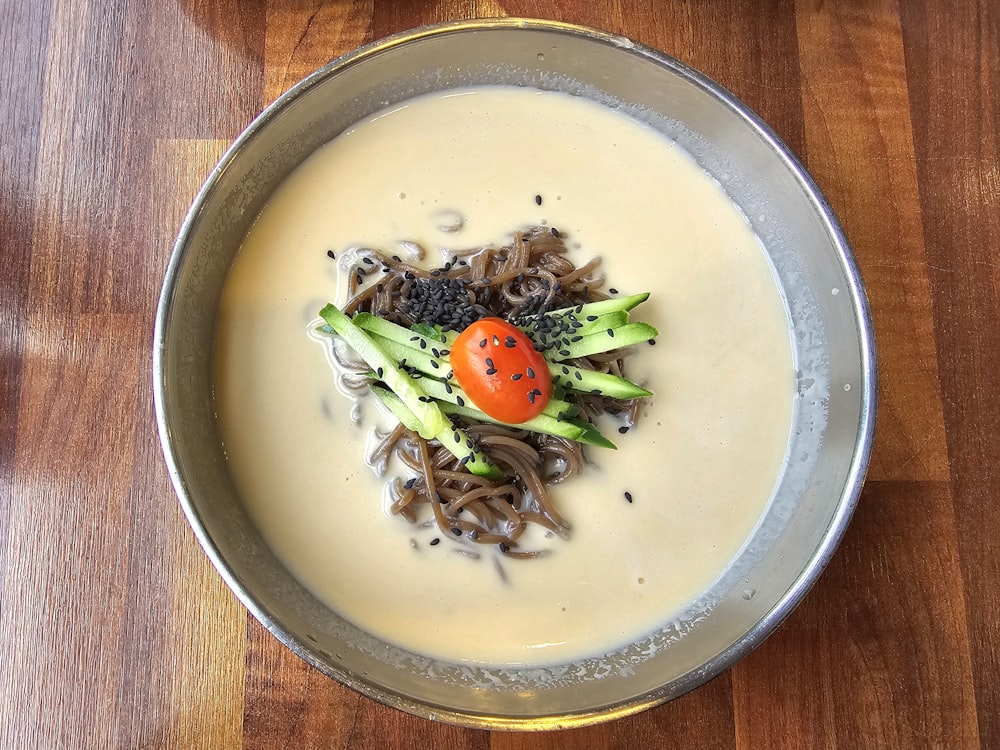 a bowl of food on a wooden table